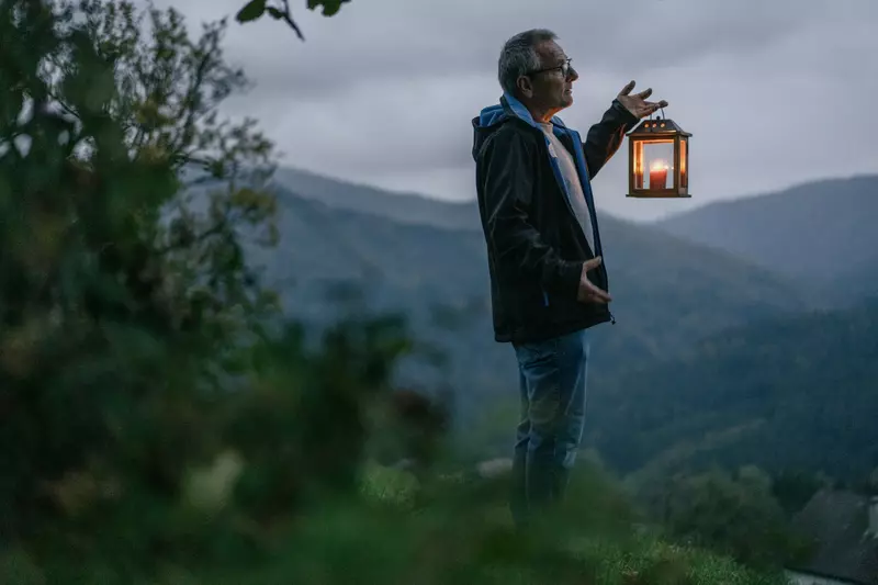 Guide mit Laterne in der Dämmerung